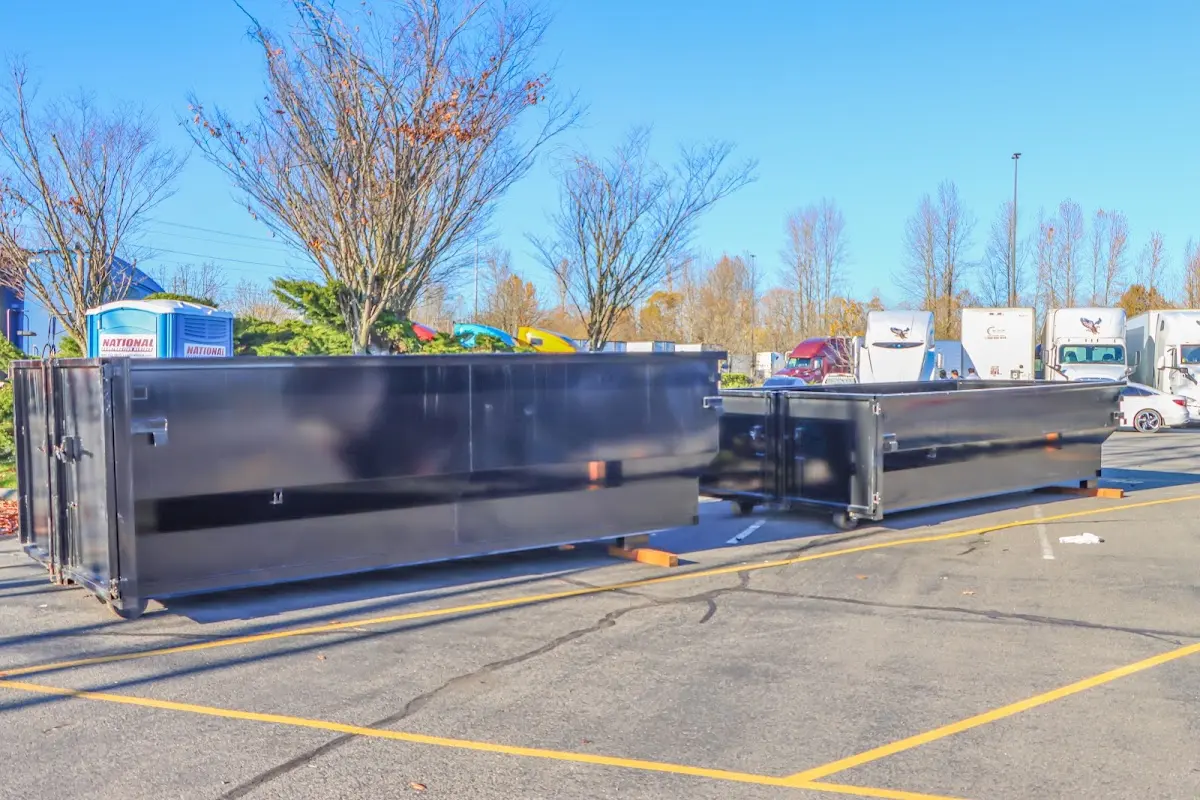 Professional dumpster rental service with roll-off container on residential driveway in Paloma Creek South